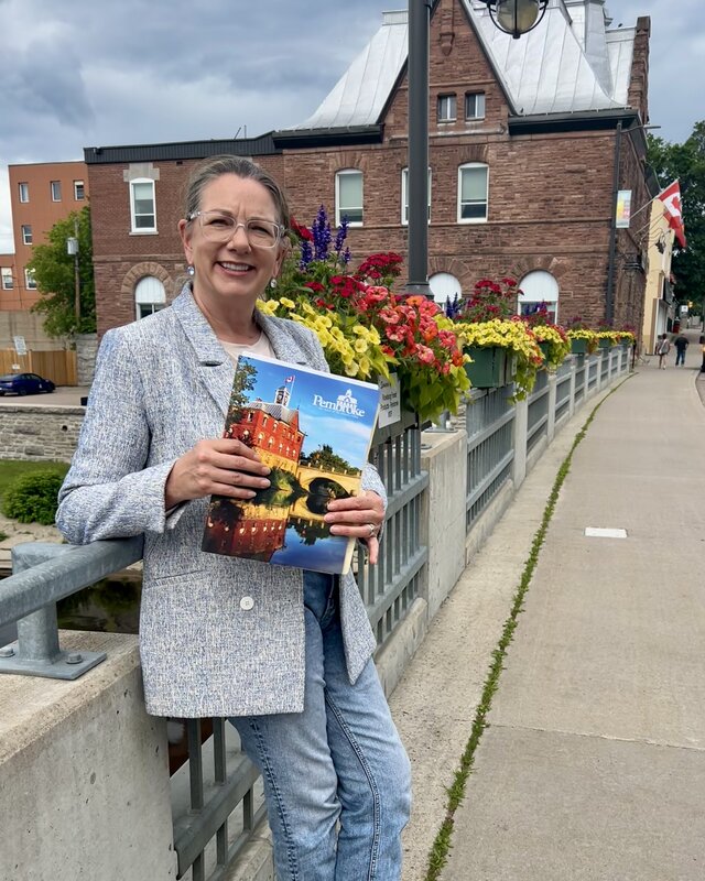 Krista Zingel on the Pembroke Street bridge, with City Hall behind her